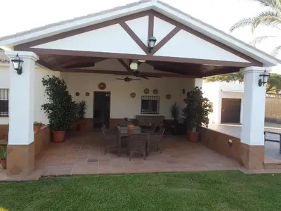 a pavilion with a table and chairs on a patio at ABULAGAR in Rota