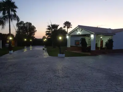 a house with a cobblestone driveway next to a building at ABULAGAR in Rota