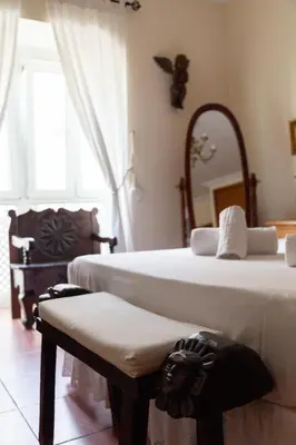 a bedroom with two beds and a mirror and a bench at La casa del mar by Gades Gestión in Cádiz