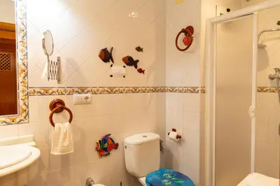 a bathroom with a toilet and a sink at La casa del mar by Gades Gestión in Cádiz