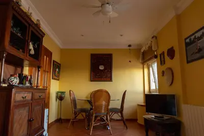 a dining room with a table and chairs and a television at La casa del mar by Gades Gestión in Cádiz