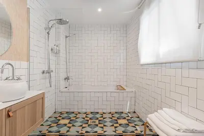 a bathroom with a tub and a sink at Art Suites by Casa de Indias in El Puerto de Santa María