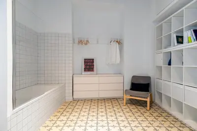 a bathroom with a tub and a chair at Art Suites by Casa de Indias in El Puerto de Santa María
