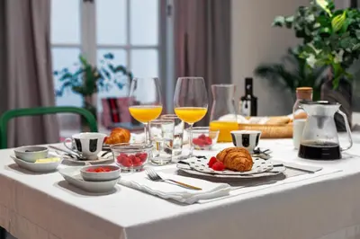 a table with food and glasses of orange juice at Art Suites by Casa de Indias in El Puerto de Santa María