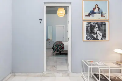 a living room with a mirror and a table at Art Suites by Casa de Indias in El Puerto de Santa María