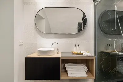 a bathroom with a sink and a mirror at Art Suites by Casa de Indias in El Puerto de Santa María