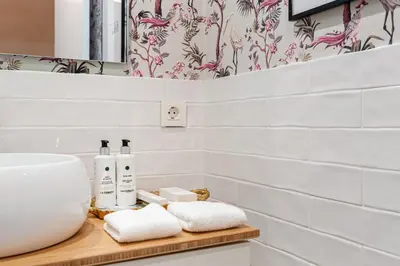 a bathroom with a sink and towels on a counter at Art Suites by Casa de Indias in El Puerto de Santa María