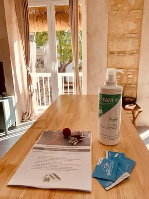 a bottle of cream sitting on a table next to a book at Feel the Sherry experience2 by Musgo in Jerez de la Frontera