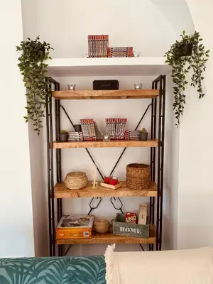 a room with wooden shelves with baskets and plants at Feel the Sherry experience2 by Musgo in Jerez de la Frontera