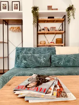 a table with a magazine on top of a couch at Feel the Sherry experience2 by Musgo in Jerez de la Frontera