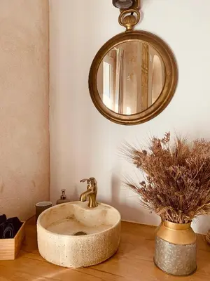 a bathroom sink with a gold faucet and a mirror at Feel the Sherry experience2 by Musgo in Jerez de la Frontera