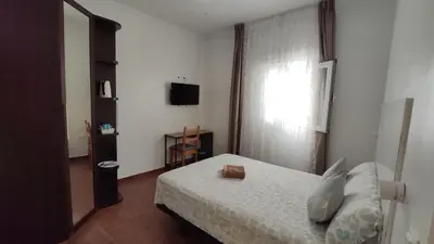 a small bedroom with a bed and a window at Dormir en Cádiz in Cádiz