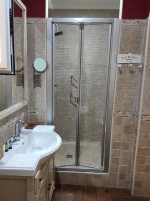 a bathroom with a shower and a white sink at Dormir en Cádiz in Cádiz