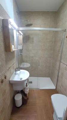 a bathroom with a shower and a sink and a toilet at Dormir en Cádiz in Cádiz