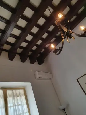 a chandelier hanging from a ceiling in a room at Twins' Home Chancillería, Jerez Centro, Cádiz, wifi in Jerez de la Frontera