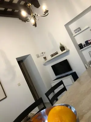 a dining room with a table and a television at Twins' Home Chancillería, Jerez Centro, Cádiz, wifi in Jerez de la Frontera