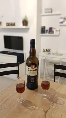 a bottle of beer sitting on a table with two glasses at Twins' Home Chancillería, Jerez Centro, Cádiz, wifi in Jerez de la Frontera