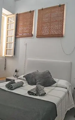 a bed in a bedroom with two pillows on it at Twins' Home Chancillería, Jerez Centro, Cádiz, wifi in Jerez de la Frontera