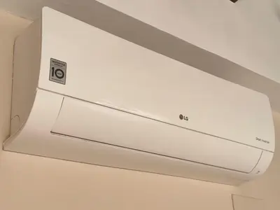 a white air conditioner hanging from a ceiling at La Caleta - La Viña in Cádiz