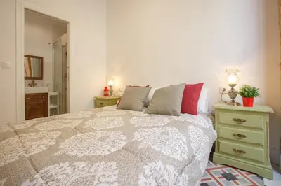 a bedroom with a bed and a dresser with a bed sidx sidx sidx sidx at Casa Del COLECCIONISTA by Cadiz4Rentals in Cádiz