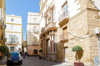 a car parked on a street next to buildings at Casa Del COLECCIONISTA by Cadiz4Rentals in Cádiz