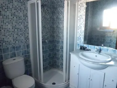 a bathroom with a sink and a shower and a toilet at NOVO Apartahotel & Restaurante in Las Cabezas de San Juan