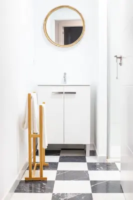 a bathroom with a mirror and a checkered floor at Apartamento Argantonio by Cadiz Time in Cádiz