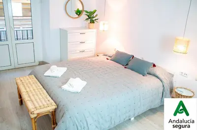 a bedroom with a bed with two towels on it at Apartamento Argantonio by Cadiz Time in Cádiz
