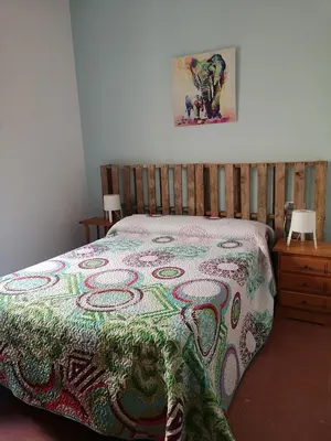a bedroom with a bed with a colorful blanket on it at Corazón del Puerto de Santa María in El Puerto de Santa María
