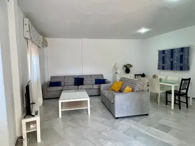 a living room with a couch and a table at Apartamento Alextia La Barrosa in Chiclana de la Frontera