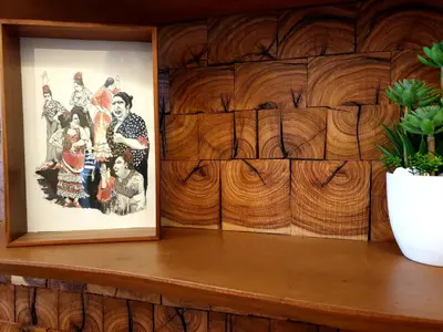 a picture sitting on a wooden shelf next to a plant at Sherryflat Senovilla in Jerez de la Frontera