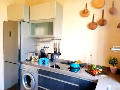 a kitchen with a refrigerator and a washing machine at Sherryflat Senovilla in Jerez de la Frontera