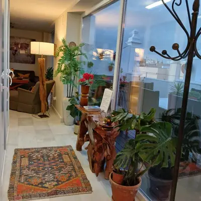 a living room with a table with a laptop on it at ***** ATTIC WITH IMPRESSIVE VIEWS AND JACUZZI in Cádiz
