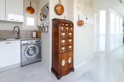 a kitchen with a washer and a washing machine at ***** ATTIC WITH IMPRESSIVE VIEWS AND JACUZZI in Cádiz