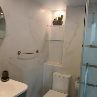 a white bathroom with a toilet and a sink at ***** ATTIC WITH IMPRESSIVE VIEWS AND JACUZZI in Cádiz