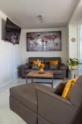 a living room with a couch and a table at ***** ATTIC WITH IMPRESSIVE VIEWS AND JACUZZI in Cádiz