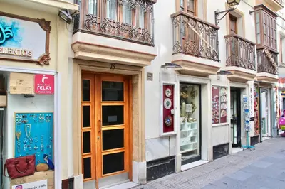 a street in a city with shops and buildings at San Francisco 15 in Cádiz