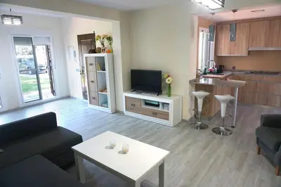 a living room with a couch and a table at Relax y playa en la Barrosa in Chiclana de la Frontera