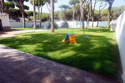a yard with a playground with a slide at Relax y playa en la Barrosa in Chiclana de la Frontera