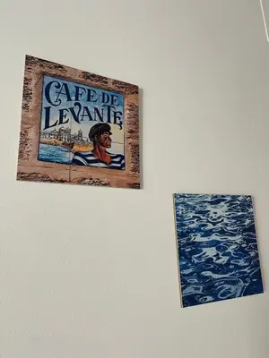 two posters on the wall of a room with water at El Chicuco en el corazón de Cádiz Grupo AC Gestion in Cádiz