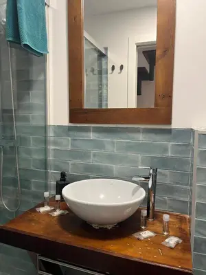 a bathroom with a white bowl sink on a counter at El Chicuco en el corazón de Cádiz Grupo AC Gestion in Cádiz
