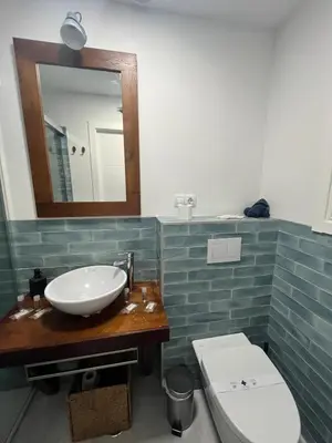 a bathroom with a sink and a toilet and a mirror at El Chicuco en el corazón de Cádiz Grupo AC Gestion in Cádiz