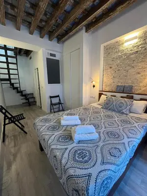 a bedroom with a large bed with two pillows on it at El Chicuco en el corazón de Cádiz Grupo AC Gestion in Cádiz