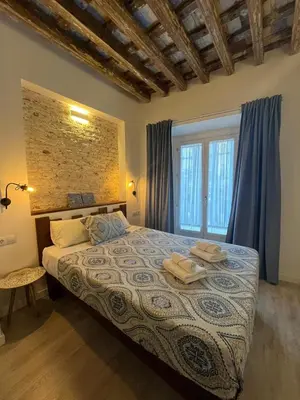 a bedroom with a bed with two towels on it at El Chicuco en el corazón de Cádiz Grupo AC Gestion in Cádiz
