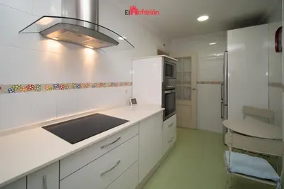 a white kitchen with a sink and a stove at ATICO NUEVO en el BARRIO ALTO SANLÚCAR in Sanlúcar de Barrameda