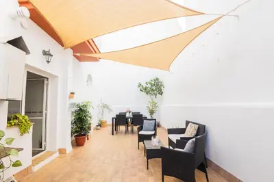 an open living room with chairs and a table at Almijar 9 in Sanlúcar de Barrameda