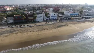 an aerial view of the beach and buildings at Almijar 9 in Sanlúcar de Barrameda