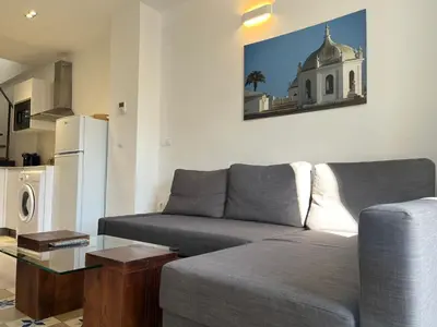 a living room with a couch and a table at Penthouse La plaza en Cádiz Centro Grupo AC Gestion in Cádiz