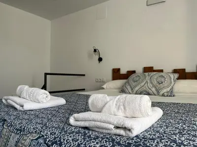 two towels are sitting on top of a bed at Penthouse La plaza en Cádiz Centro Grupo AC Gestion in Cádiz