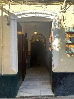 an entrance to a building with a black door at Penthouse La plaza en Cádiz Centro Grupo AC Gestion in Cádiz